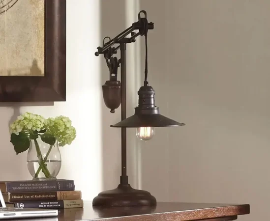 Vintage table lamp beside flowers and books.